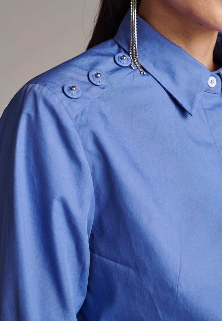 Sharp-shouldered men-inspired shirt detailed with cup chain. The crystal-embellished detachable fringing spotlights add a seductive twist to this blue shirt. Concealed front button closure. Curved hem. Cut from 100% cotton poplin. Made in Lithuania.
